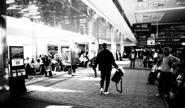 Lined up along the moving walkways waiting for our plane to arrive from Chicago